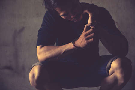 criminal tying hands with handcuffs.の写真素材