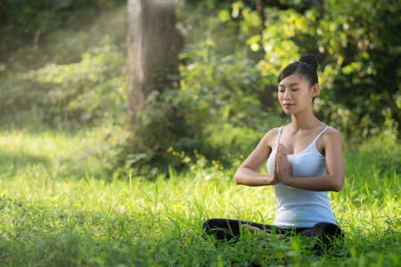 asian woman playing yoga in waterfall outdoor nature background.の写真素材