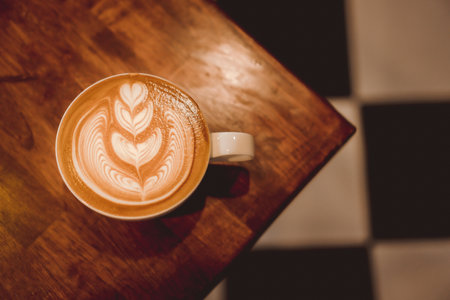 coffee latte art on wood table, relax time, cafe barista art top view.の写真素材