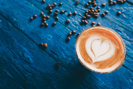 coffee latte art on wood table, relax time, cafe barista art top view.の写真素材