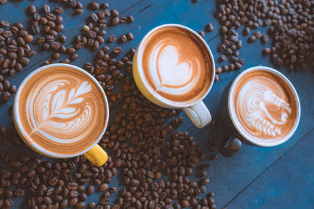 coffee latte art on wood table, relax time, cafe barista art top view.の写真素材