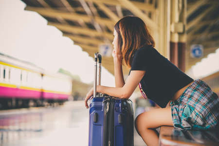 asian woman holding coffee cup and phone.の写真素材