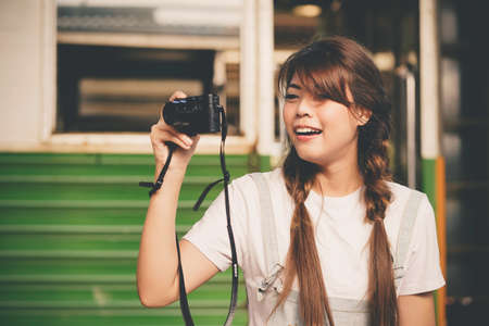 Happy shopper asian woman holding a shopping bagの写真素材