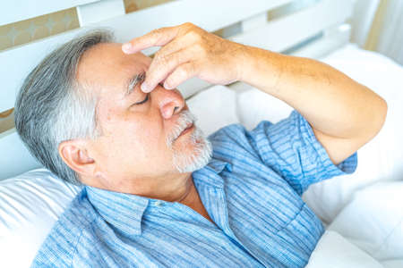 Mature man have a headache.