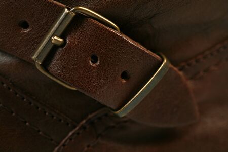 Metal buckle on a brown leather product