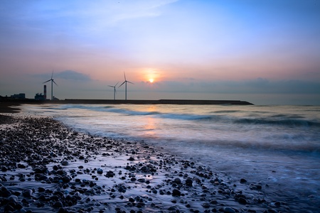 Reflection of the sunset and windmill の写真素材