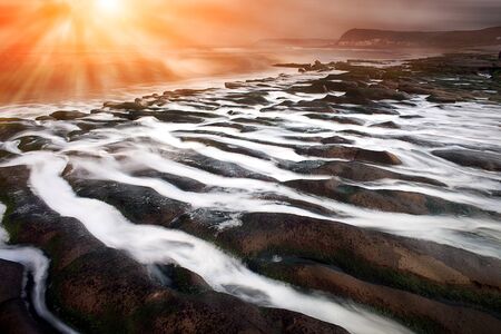 Rocky Seacoast full of green seaweed, long time exposure, Taiwan, East Asia の写真素材