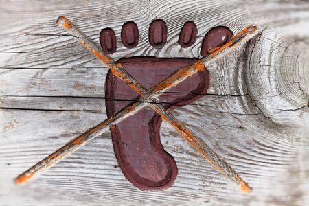 Stop sign engrave on wood. Do not touch by  foot の写真素材