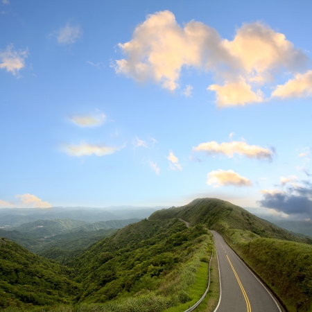 Green road with blue sky best for car adv use の写真素材