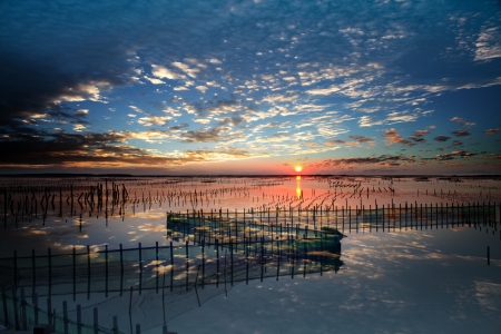 beautiful sunset and cloud reflection on the sea and lakeの写真素材