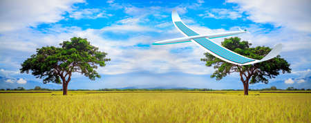 Solar energy airplane on field landscape