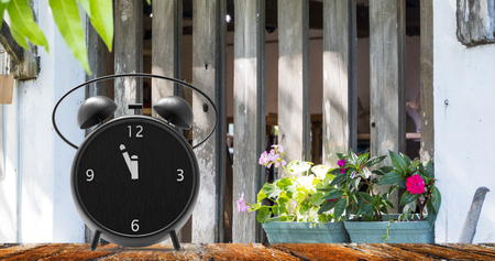 The alarm clock with little minutes to twelve o'clock