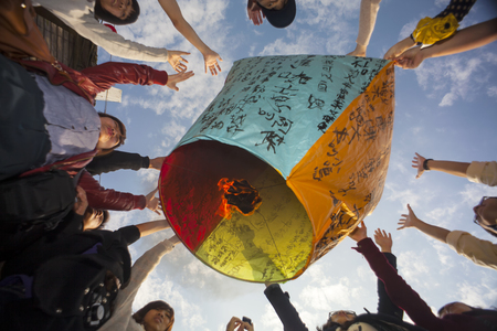 New Taipei, Taiwan - Feb 5, 2012: Tourists Launching Sky Lantern Along Railway Next to Shifen Train Station of Pingxi Line (Most Beautiful Branch Line in Taiwan Railway System)のeditorial素材