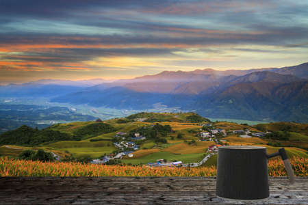 The coffee cup on the balcony in the plate with nice view and background