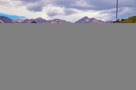 Large cabin housing in the mountains with hills of aspen in backgroundの写真素材