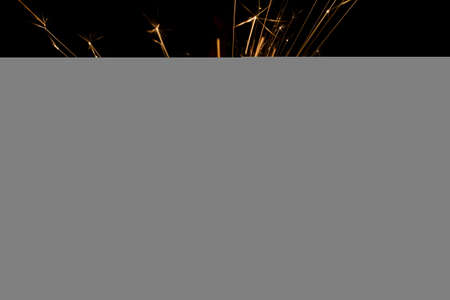 Lit sparkler shooting off sparks in the night