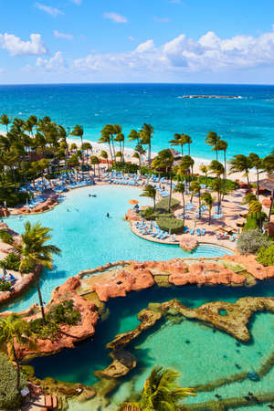 View from caribbean resort with pools, palm trees, and wildlifeの写真素材