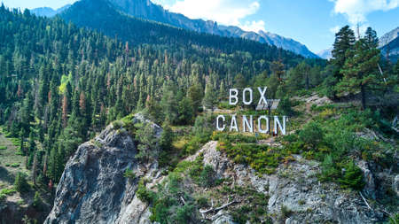 Box Canon sign at the top of mountain with forests of pine trees aroundの写真素材