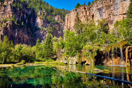 Large mountain view next to lake with waterfallの写真素材