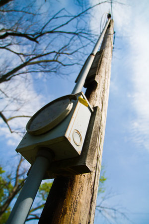 Telephone pole with utility meter reaching towards the skyの写真素材