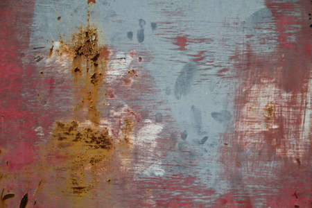 Red and blue wall background with rust marksの写真素材