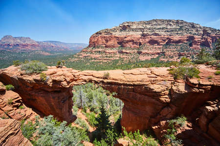Cliff in the foreground with large multicolored rocky outcropping Devils Bridgeの写真素材