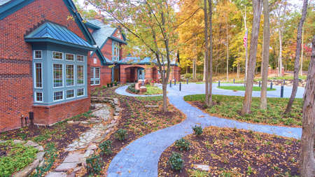Fall landscaping next to brick building with pathsの写真素材