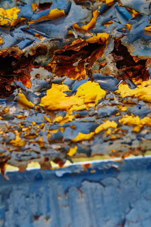 Yellow paint peeling off an abandoned old wall at a closed amusement parkの写真素材