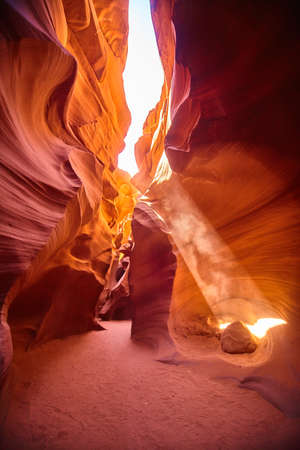 Light filters in at an angle through an orange canyonの写真素材