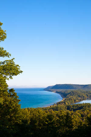 Portrait view from up high of a lake surrounded by beaches and treesの写真素材