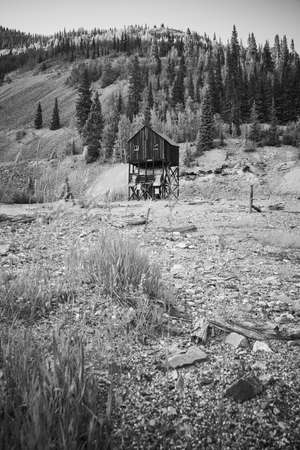Black and white of desert field and mountains with mining building in distanceの写真素材