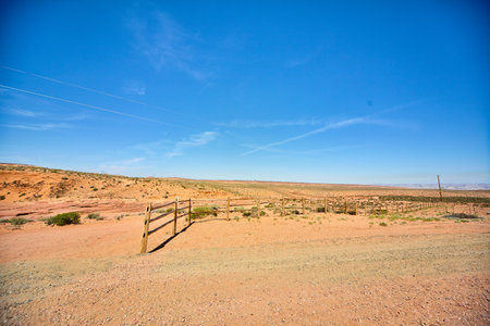 Abandoned fence leads to nowhere in the middle of a desertの写真素材
