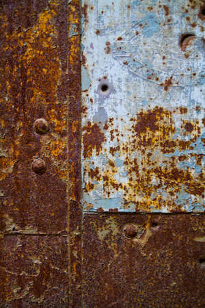 Rusted antique metal background with pockmarks and a section of gray steelの写真素材