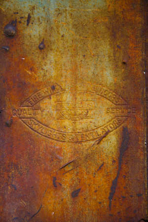Rusted antique metal background with old embossed symbol