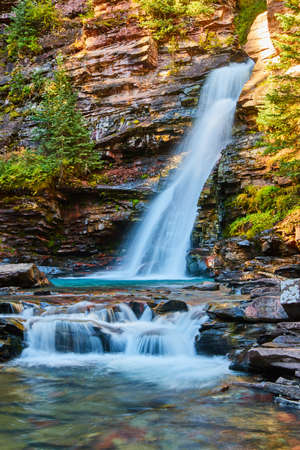 Beautiful waterfall in canyon with peaceful tranquil vibesの写真素材