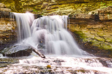 Close up of waterfall splashing against rocksの写真素材
