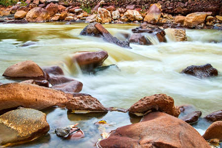 Close up of river with minerals and red rocksの写真素材