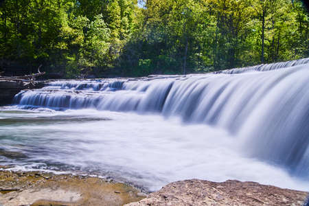 Water gushing over waterfall in forest