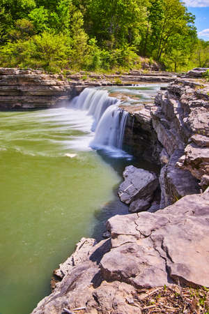 Cliff edge next to large waterfall gorgeの写真素材