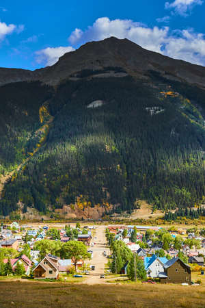 Large mountain behind town in the mountainsの写真素材