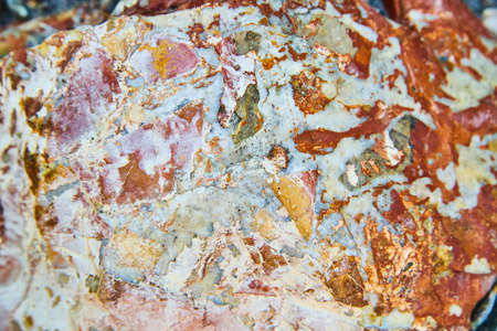 Colorful rock texture with red and blue patchesの写真素材