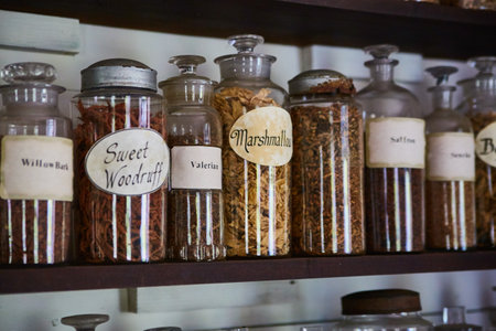 Spices and herbs in rustic and labeled bottles on a shelf