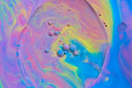 Swirl of light rainbow colors with floating orbsの写真素材