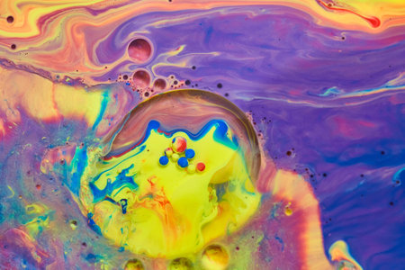 Mystical rainbow of colors on liquid surface with tiny acrylic spheres
