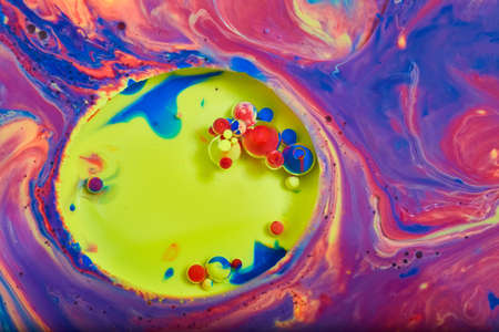 Yellow circle of tiny colorful orbs surrounded by rainbow of colorsの写真素材