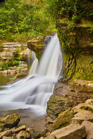 Cascading falls over mossy stones with a jungle type vibeの写真素材
