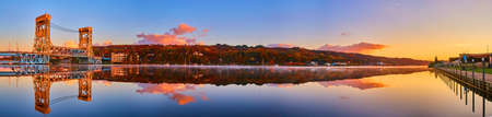 Panorama of Houghton harbor with lift bridge and glassy river surface and docks in the fallの写真素材
