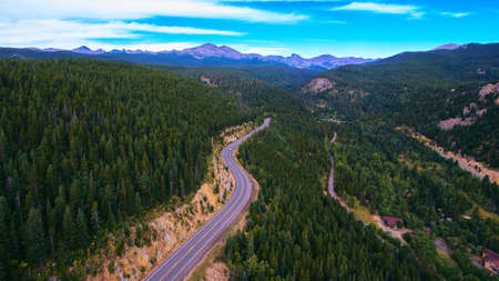 Highway road travel through the country mountains and forest of pine treesの写真素材