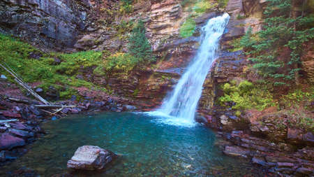 Beautiful blue and teal waterfall in rock canyonの写真素材