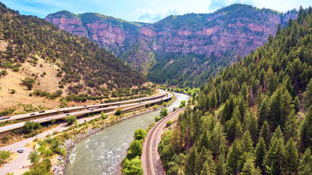 Colorado rocky mountain valley with highway and riverの写真素材